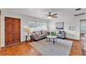 Bright living room with hardwood floors, neutral furniture, and large window at 1032 Tower Blvd, Lake Wales, FL 33853
