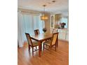 Formal dining area with hardwood floors, decorative lighting, and cabinet storage at 11 Navel Dr, Winter Haven, FL 33884