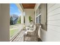 Inviting porch with wicker chairs, offering a relaxing outdoor seating area at 1162 E Highland Dr, Lakeland, FL 33813