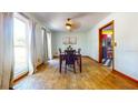Bright dining room with hardwood floors, a modern chandelier, and large windows that let in plenty of natural light at 1432 Libby Rd, Babson Park, FL 33827