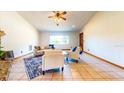 Spacious living area with tile flooring and lots of natural light from a large window overlooking the outdoors at 1432 Libby Rd, Babson Park, FL 33827