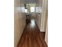 Hallway with wood-laminate flooring that leads to the kitchen at 148 Sweet Cir, Winter Haven, FL 33884