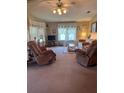 Cozy living room with comfortable armchairs and a large window for natural light at 148 Sweet Cir, Winter Haven, FL 33884