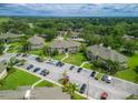 Condo community showcasing multiple buildings, ample parking, and a variety of lush trees and landscaping at 1503 Eagle Pond Dr # 1503, Winter Haven, FL 33884