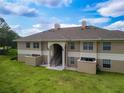 Attractive condo building with two stories, neutral colors, and well-maintained lawn, offering a peaceful setting at 1503 Eagle Pond Dr # 1503, Winter Haven, FL 33884