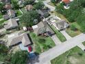 An aerial view of the neighborhood showing lush greenery and well-maintained homes on a sunny day at 1506 Chamberlain Loop, Lake Wales, FL 33853