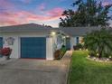 Charming home with a blue garage door, beautiful landscaping, and a well-maintained lawn at 1531 Oakview Se Cir, Winter Haven, FL 33880