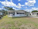 Lovely single-story home with white exterior, black shutters, covered porch, and manicured lawn at 1534 Longbow Dr, Lakeland, FL 33810