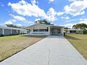 Inviting single-story home featuring a long driveway and a well-kept lawn with lush green grass at 1534 Longbow Dr, Lakeland, FL 33810