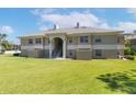 Back of the condo with green lawn and stairs to second floor units at 1602 Eagle Pond Dr # 1602, Winter Haven, FL 33884
