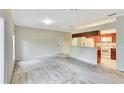 View of the living room with neutral walls and a kitchen bar at 1602 Eagle Pond Dr # 1602, Winter Haven, FL 33884