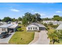 An inviting single-story home with a paved driveway, carport, and lush green lawn at 1610 Reynolds Rd # 72, Lakeland, FL 33801