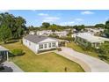 Quaint single-story home featuring a convenient carport, lush lawn, and inviting paved driveway at 1610 Reynolds Rd # 72, Lakeland, FL 33801
