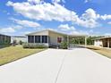 Inviting single-story home with a covered carport and screened-in porch providing ample space for parking and relaxation at 1746 Fox Hill Dr, Lakeland, FL 33810