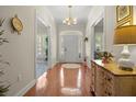 Bright foyer with wood floors, decorative chandelier, and an arched doorway at 195 E Conant St, Bartow, FL 33830