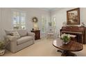 Cozy living room featuring comfortable seating, piano, and many windows at 195 E Conant St, Bartow, FL 33830