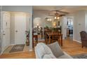 Open-concept living room and dining room with beautiful laminate flooring and neutral color scheme at 210 Citrus Dr, Winter Haven, FL 33884
