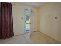 Bright entryway with a patterned floor and a view of the front yard through an open door at 219 Willow St, Lake Wales, FL 33859