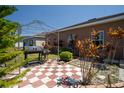 Backyard patio features a checkered tile design and a cozy pergola at 249 Haines Blvd, Winter Haven, FL 33881