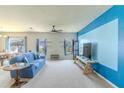 Bright living room with neutral carpet and a distinctive accent wall at 249 Haines Blvd, Winter Haven, FL 33881