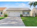 Single-story home featuring an attached garage, neutral paint, well-maintained landscaping and long driveway at 259 Mariposa, Winter Haven, FL 33884