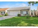 Attractive single Gathering home boasting a tiled roof, attached garage, and lush green lawn at 259 Mariposa, Winter Haven, FL 33884