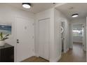 Hallway with updated lighting and laminate flooring, leading to bedrooms and bathrooms at 259 Mariposa, Winter Haven, FL 33884