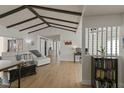 Bright living room featuring vaulted ceilings, wood beams, and hardwood floors at 259 Mariposa, Winter Haven, FL 33884