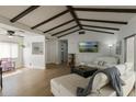Spacious living room featuring hardwood floors, a white sectional couch, and ample natural light at 259 Mariposa, Winter Haven, FL 33884