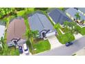 An aerial view of a single-story home with a gray roof, two-car garage and green lawn at 2721 Kokomo Loop, Haines City, FL 33844