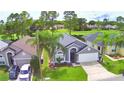 A well-maintained single-story home with a two-car garage, green lawn and located on a golf course at 2721 Kokomo Loop, Haines City, FL 33844