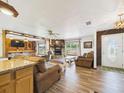 Spacious living room with wood accents, stone fireplace, natural light, and comfortable seating at 2726 Prine Rd, Lakeland, FL 33810