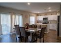 Elegant dining room with marble table, comfortable seating, and natural light from sliding glass doors at 3440 Dahlia Dr, Haines City, FL 33844