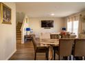 Open-concept living area with hardwood floors and a large TV, perfect for entertaining and relaxation at 3440 Dahlia Dr, Haines City, FL 33844