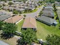 Aerial view of a well-planned community with manicured lawns and houses with brown roofs at 3565 Raleigh Dr, Winter Haven, FL 33884