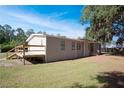 Exterior view of home featuring a wooden deck and a well-maintained lawn at 3611 Island Oaks Ct, Lakeland, FL 33805