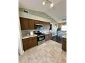 Modern kitchen featuring tile floors, dark cabinetry, and stainless steel appliances at 3851 Horizon View Loop, Lakeland, FL 33813