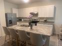 Bright kitchen with granite countertops and stainless steel appliances at 386 Feltrim Reserve Blvd # 386, Davenport, FL 33837