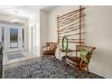 Inviting foyer with bamboo art piece, chairs, side table, and area rug creating a warm, stylish entrance at 4148 Dunmore Dr, Lake Wales, FL 33859