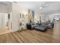 Open-concept living room featuring hardwood floors, a large gray sectional, and stylish decor at 4148 Dunmore Dr, Lake Wales, FL 33859