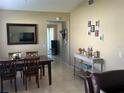 Open dining room featuring tile floors, a modern light fixture, and view to patio at 423 Greenfield Rd, Winter Haven, FL 33884