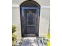 The front entryway has a secure screen door and leads to a shaded porch with an arched entryway at 4333 Pumice Dr, Lakeland, FL 33811