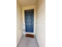 The entryway of the home has a blue door and a welcome mat at 4333 Pumice Dr, Lakeland, FL 33811