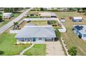 Aerial view of the property with a spacious fenced backyard and metal roof at 498 W 7Th St, Frostproof, FL 33843