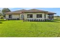 Home exterior with manicured lawn, features a well-maintained yard at 553 Thornburg Rd, Babson Park, FL 33827