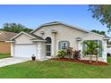 Attractive one-story home featuring a two-car garage, tidy landscaping, and a bright, welcoming entrance at 59 Saint Kitts Cir, Winter Haven, FL 33884
