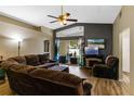 Comfortable living room featuring plush furniture, a ceiling fan, and sliding glass doors to the outside at 59 Saint Kitts Cir, Winter Haven, FL 33884