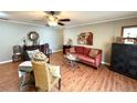 Cozy living room features stylish furniture, ceiling fan, and lots of natural light at 605 Wanamaker Ave, Fort Meade, FL 33841