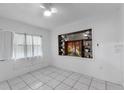 Bright bedroom featuring a custom display case and a large window at 608 William Ave, Winter Haven, FL 33880