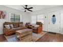 Comfortable living room featuring a stylish rug, leather furniture, and large windows at 608 William Ave, Winter Haven, FL 33880